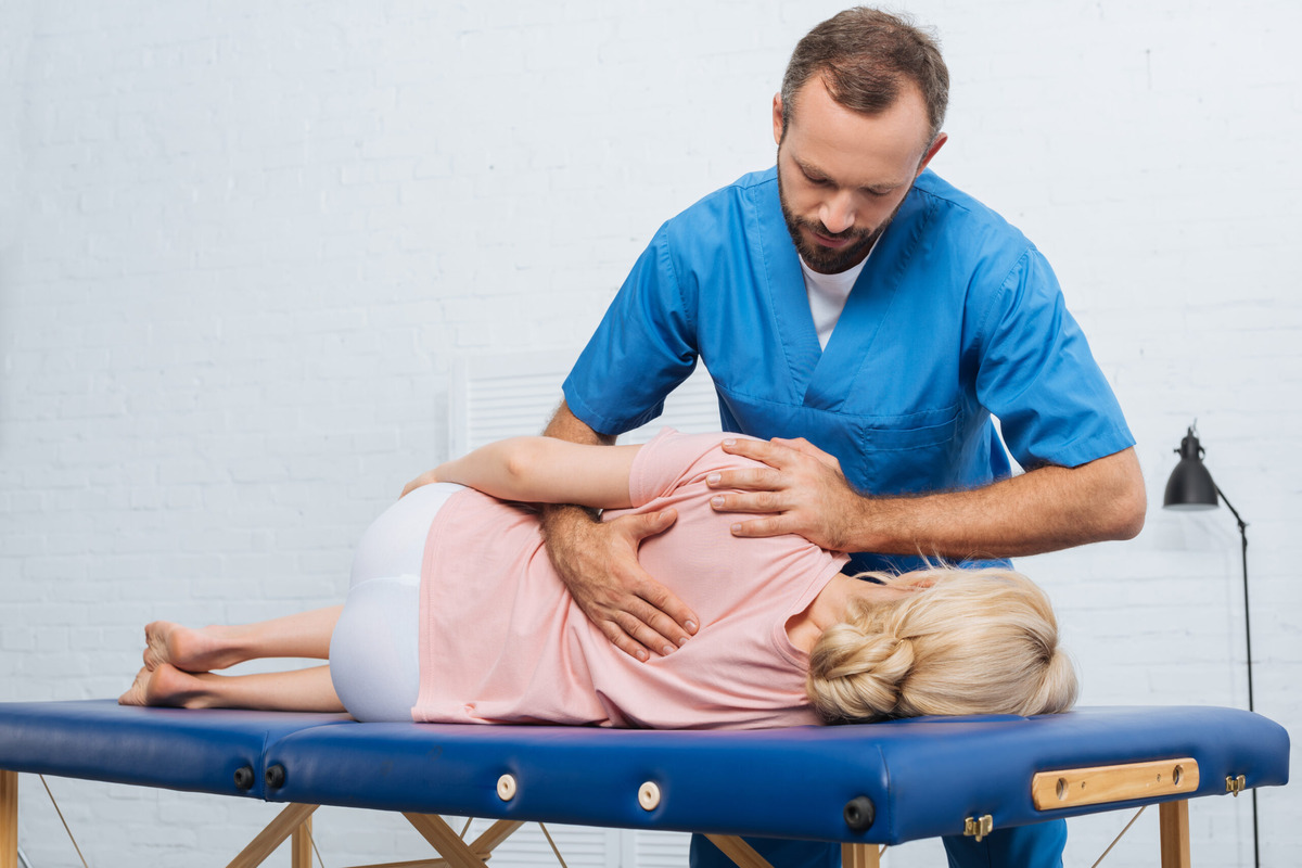 portrait-of-chiropractor-massaging-back-of-patient